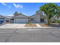 Charming single-story home featuring a well-maintained lawn, attached garage, and a welcoming front entrance at 6181 Cedarwood Ave, Las Vegas, NV 89103