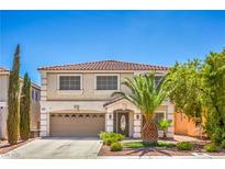 Charming two-story home with a well-manicured lawn, two-car garage, and mature palm tree at 6559 Musette Ave, Las Vegas, NV 89139