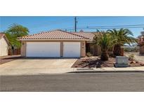 Charming home with desert landscaping, two-car garage, and red tile roof at 688 Arrowhead Canyon Dr, Henderson, NV 89002