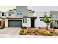 Contemporary two-story home featuring a brick driveway, 2-car garage and low-maintenance landscaping at 10280 Midnight Meteor Ave, Las Vegas, NV 89166