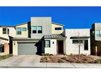 Two-story home featuring modern architecture, a two car garage and desert landscaping at 10280 Midnight Meteor Ave, Las Vegas, NV 89166