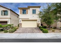 Inviting two-story home with a two-car garage and a beautifully paved driveway and stone accents at 10512 Mann St, Las Vegas, NV 89141