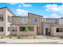 A modern townhome showcasing a neutral color palette, drought-resistant landscaping, and a charming covered entry at 11407 Ethereal Landing Ave, Las Vegas, NV 89138