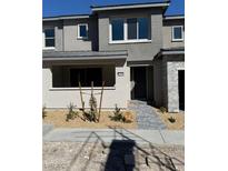 Charming townhome featuring a low maintenance desert landscaped front yard and a covered porch at 11423 Ethereal Landing Ave, Las Vegas, NV 89138