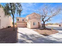 Inviting two-story home featuring desert landscaping and a spacious driveway on a sunny day at 2407 Belt Buckley Dr, Henderson, NV 89002