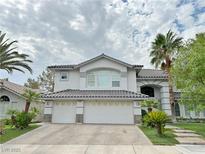 Stately two-story home with a three-car garage and desert landscaping, blending elegance and practicality at 2451 Tour Edition Dr, Henderson, NV 89074
