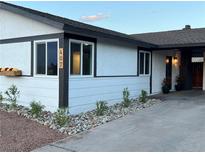 Charming single-story home with fresh exterior paint, landscape rock, and decorative flower boxes at 407 Tiger Lily Way, Henderson, NV 89015