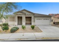 Charming single-story home featuring a well-maintained front yard and a two-car garage at 5833 Craigmore Ln, North Las Vegas, NV 89031