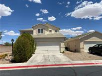 Two story home featuring a driveway leading to a two-car garage and a detached one-car garage at 7748 Catalina Harbor St, Las Vegas, NV 89131