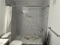 Modern bathroom featuring stylish marble-look tile in the shower at 7885 W Flamingo Rd # 2019, Las Vegas, NV 89147