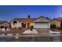 Charming single-story home boasts a red tile roof, two-car garage, and desert landscaping at 8613 Linderwood Dr, Las Vegas, NV 89134
