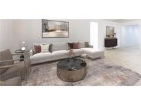 Bright living room featuring a modern sectional sofa, stylish decor, and contemporary furnishings on a patterned rug at 10742 Cowlite Ave, Las Vegas, NV 89166