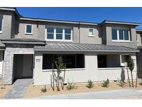Inviting home exterior with a contemporary design, neutral color palette, and well-manicured landscaping at 11427 Ethereal Landing Ave, Las Vegas, NV 89138