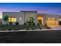 Contemporary home showcasing clean lines, desert landscaping, and a two-car garage at 11895 Skyline Arch Ct, Las Vegas, NV 89138