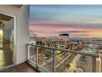 Enjoy panoramic city views from the balcony with glass railings at dusk at 150 N Las Vegas Blvd # 804, Las Vegas, NV 89101