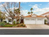 Charming single-story home with a three-car garage, mature trees, and desert landscaping at 1933 Davina St, Henderson, NV 89074
