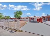 Charming single-story home featuring a carport, fresh exterior paint, and a secure gated front yard at 2016 Linden Ave, Las Vegas, NV 89101