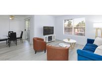 Bright living room with modern furniture, sleek floors, and a cozy dining area at 2300 E Silverado Ranch Blvd # 1165, Las Vegas, NV 89183