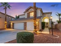Charming two-story home featuring a three-car garage, stone accents, and manicured landscaping at 2639 Regency Cove Ct, Las Vegas, NV 89121