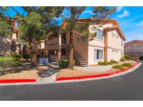 Low angle view of apartment building exterior with stairs and desert landscaping in front and visible parking restrictions at 350 S Durango Dr # 108, Las Vegas, NV 89145