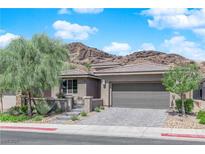 Charming single-story home with a two-car garage, neat landscaping, and a picturesque mountain backdrop at 40 Vicolo Della Luna, Henderson, NV 89011
