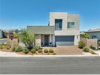 Modern two-story home with a two-car garage, stone accents, and desert landscaping at 4246 W Landberg Ave, Las Vegas, NV 89141