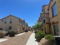 Community street view highlighting the architecture and landscaping of the homes at 4554 Townwall St, Las Vegas, NV 89115
