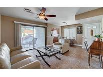 Inviting living room with neutral decor, sliding door to patio, and ceiling fan at 4860 Nara Vista Way # 204, Las Vegas, NV 89103