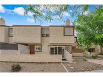 Charming townhome featuring desert landscaping and a private front patio entrance at 5029 Spencer St # D, Las Vegas, NV 89119