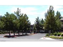 Gated community entrance with mature trees and manicured landscaping adding to the property's curb appeal at 555 E Silverado Ranch Blvd # 2147, Las Vegas, NV 89183