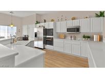 Bright kitchen features white cabinets, stainless steel appliances and a kitchen island at 6141 Markleham Ave, Las Vegas, NV 89130