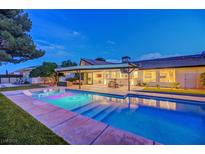 Backyard features a sparkling pool with a covered patio area, perfect for outdoor living and entertaining at 7140 Palmyra Ave, Las Vegas, NV 89117