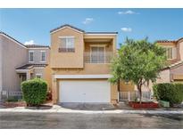 Inviting two-story home featuring a balcony, a two-car garage, and charming landscaping at 7331 Carrot Ridge St, Las Vegas, NV 89139