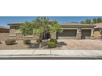 Charming single-story home featuring a three-car garage, stone accents and attractive desert landscaping at 7340 Zonal Ave, Las Vegas, NV 89131
