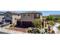 Beautiful home with a two-car garage and a lush landscaped front yard. Paved driveway at 7824 Warm Winds St, North Las Vegas, NV 89084