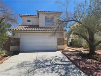 Charming two-story home with a tile roof, two car garage, and some landscaping in front at 7849 Blue Brook Dr, Las Vegas, NV 89147