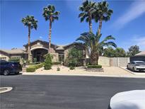 Charming single-story home boasts mature landscaping, a stone facade, and an arched entry at 8078 Leather Harness St, Las Vegas, NV 89131