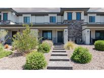 Charming townhome with stone accents and landscaped front yard at 835 Jigglypuff Pl, Henderson, NV 89011