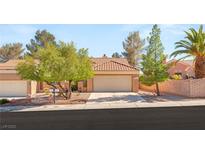 Charming single-story home featuring a well-manicured yard and two-car garage at 9445 January Dr, Las Vegas, NV 89134