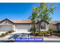 Charming single-story home features a well-manicured yard, mature trees and a two car garage at 9710 Geiger Peak Ct, Las Vegas, NV 89148