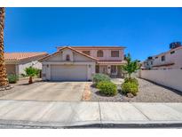 Charming two-story home featuring a tile roof, a two-car garage, and well-maintained landscaping at 982 Flapjack Dr, Henderson, NV 89014