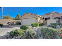 Charming single story home featuring a two-car garage, gated entry, desert landscaping, and neutral color palette at 10201 Premia Pl, Las Vegas, NV 89135