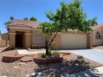 Charming single-story home features a tile roof, manicured landscaping, and a two-car garage at 1712 Matador Way, Las Vegas, NV 89128