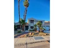 Charming two-story home featuring a landscaped yard with mature palm trees and a two car garage at 2016 Catalina Marie Ave, Henderson, NV 89074