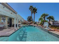 Inviting backyard pool with covered patio and mature landscaping, perfect for outdoor relaxation and entertainment at 2016 Catalina Marie Ave, Henderson, NV 89074