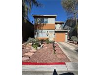 Charming two-story home featuring a well-manicured front yard and an attached one car garage at 2229 Steele St, Las Vegas, NV 89156