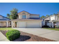 Charming two-story home with a two-car garage and well-maintained front yard landscaping and beautiful architecture at 2679 Regency Cove Ct, Las Vegas, NV 89121