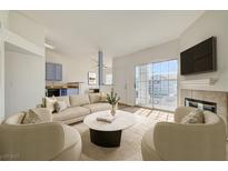 Bright living room with fireplace, large sliding doors, and tan sectional sofa and chairs at 3318 N Decatur Blvd # 2129, Las Vegas, NV 89130