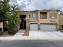 Charming two-story home with a three-car garage and stone accents on the facade at 4121 Erinbird Ave, North Las Vegas, NV 89084