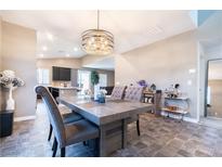 Charming dining room featuring stylish light fixture and modern decor, seamlessly connected to the kitchen at 4376 Latitude Valley Ct, North Las Vegas, NV 89084